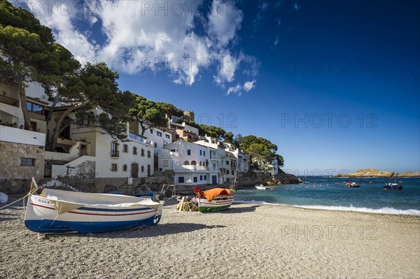 Village with beach and fishing boats on the sea