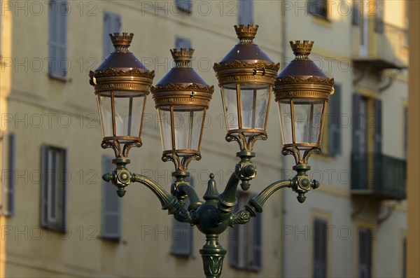 A glorious street lamp in Ajaccio and the facade of a house in the background illuminated by warm morning light. Ajaccio is the capital of the mediterranean island of Corsica
