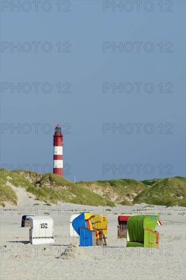 Beach with colourful beach chairs and a lighthouse
