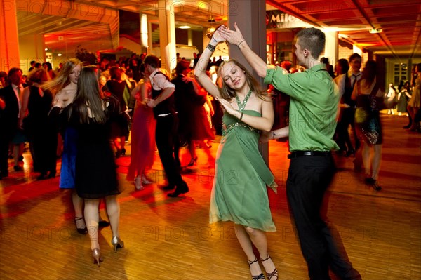 Young couple dancing at the prom of a dance school