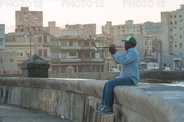 A man playing the trumpet at the Malecon