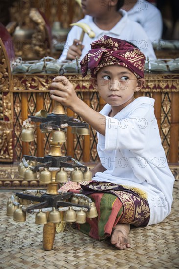 The youngest member of a gamelan orchestra at an event