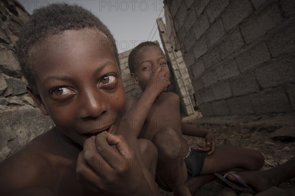 CChildren of the Rabelados religious community eating sea snails