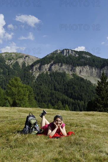 Hiker lying on the Raschoetz alp