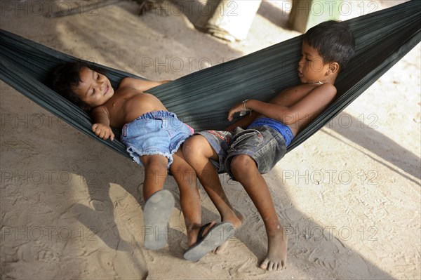 Boy and girl lying in a hammock
