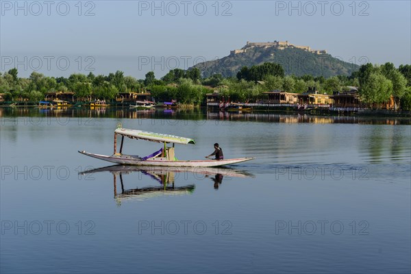 A shikara boat crossing Dal Lake