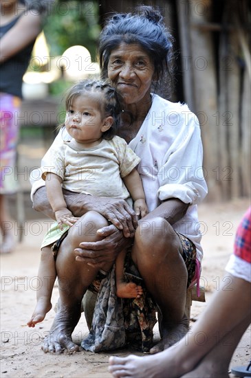 Elderly woman with a child on her lap