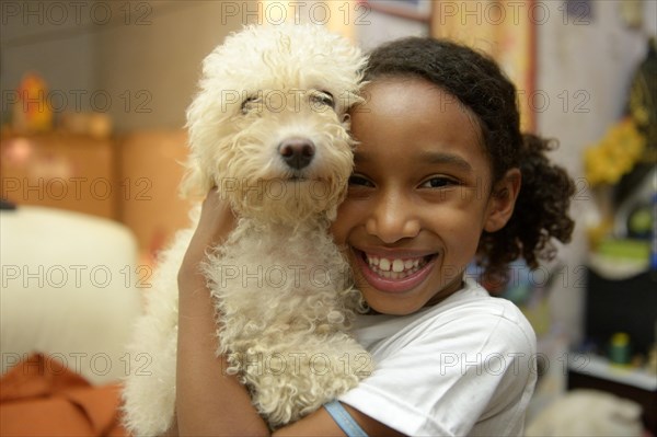Girl with a poodle in a slum or favela