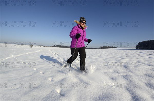Woman snowshoe walking