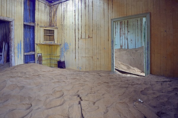 Building taken over by sand from the desert