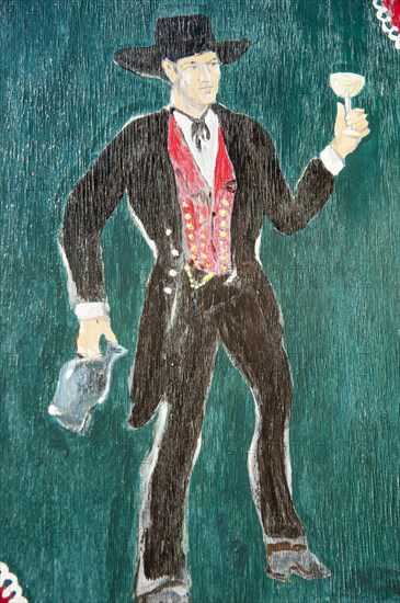 Painted window shutter with man in traditional costume