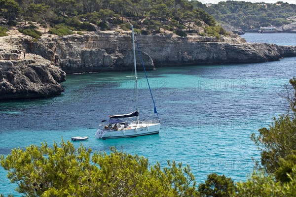 Sailing boat in the rocky bay of Calo d'en Garrot