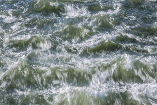 Rough waters of a river swirling after emerging from a barrage