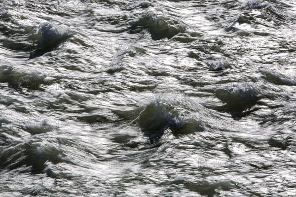 Rough waters of a river swirling after emerging from a barrage