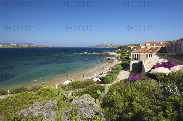 Beach of Porto Faro with the lighthouse at Capo d'Orso