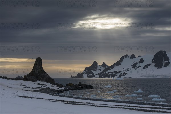 Sunrays shining through a hole in the clouds at Half Moon Island