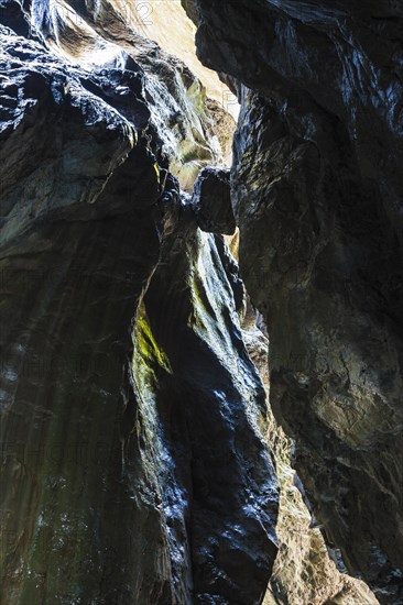 Boulder wedged between two rock faces