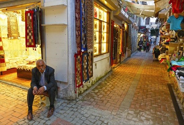 Man sitting outside a carpet shop in the Bazaar of Kusadasi