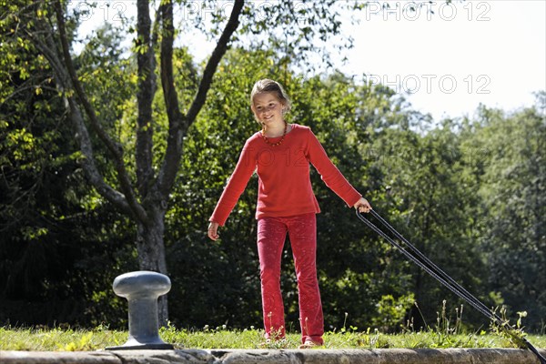 Girl fastening a rope to secure the boat in the lock chamber