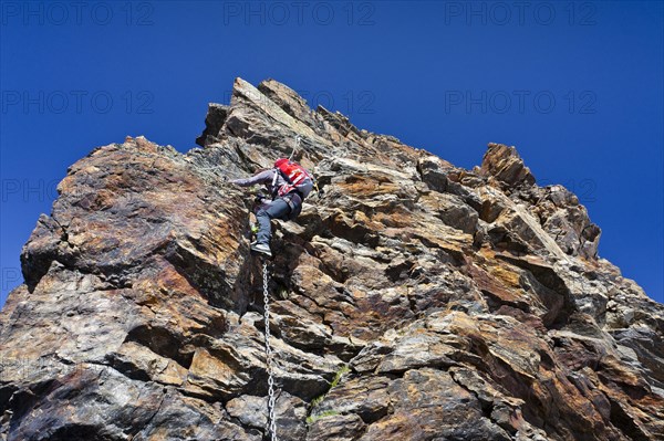 Mountain climber during the ascent of Schneebiger Nock Mountain on a climbing route in the Rieserferner Group in the Puster Valley