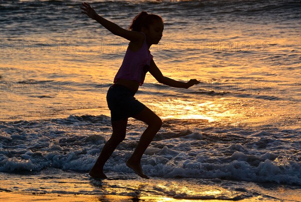 Girl playing on the beach