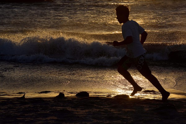 Man jogging along a beach