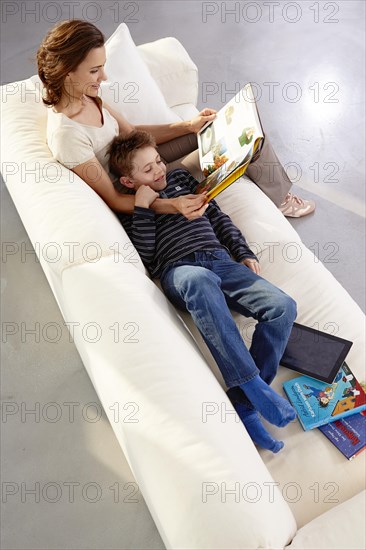 Mother and son reading on a sofa