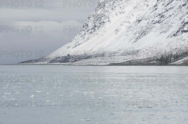 Snow-covered rocks surrounding Magdalene Fjord