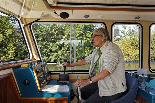Woman at the wheel of a Penichette