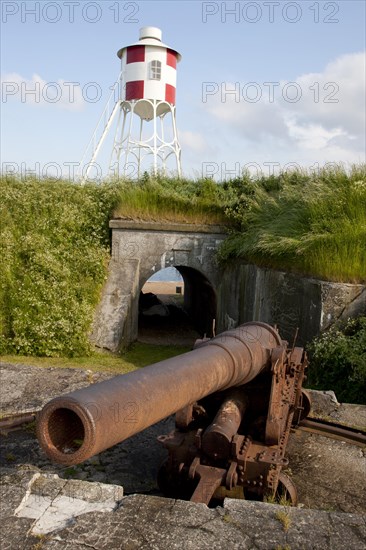 An old cannon and a beacon at Trekroner Sofort or Three Crowns Sea Fortress