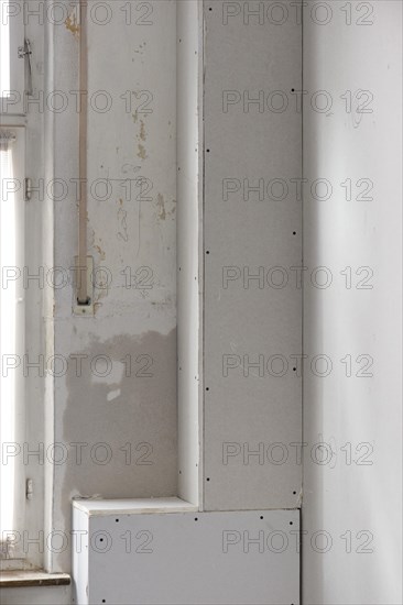 Sewer pipes covered with plasterboard panels