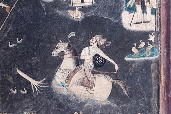 Rider on horseback crossing a river