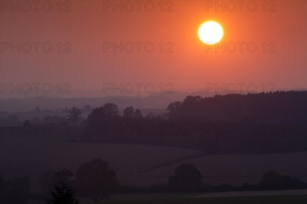 Sunset over a wooded landscape