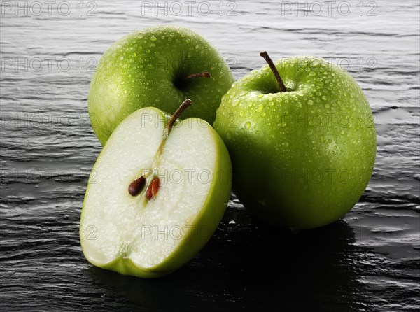 Whole and cut Granny Smith apples