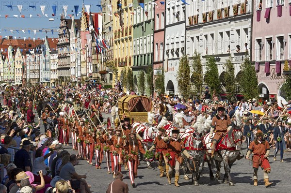 Horse-drawn golden bridal carriage and escorts