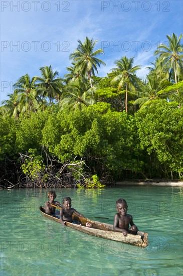 Local boys in a canoe in the Marovo Lagoon