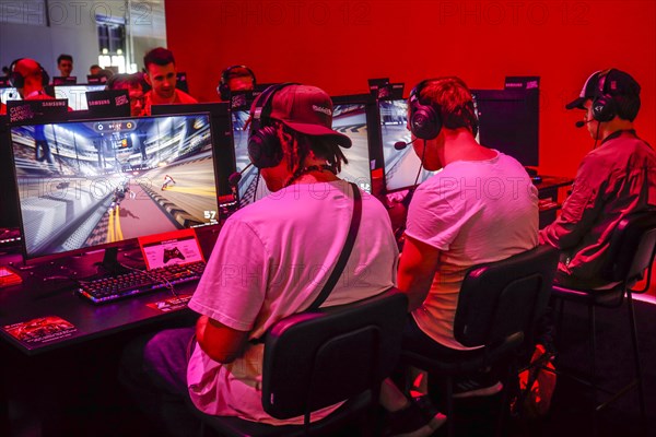 Young visitors at the computer game in front of screens