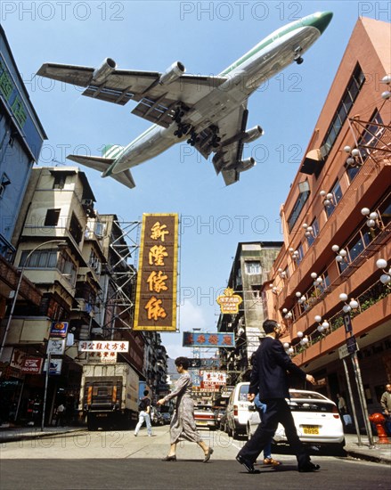 Cathay Pacific aircraft approaching Kai Tak Airport over the rooftops of Kowloon