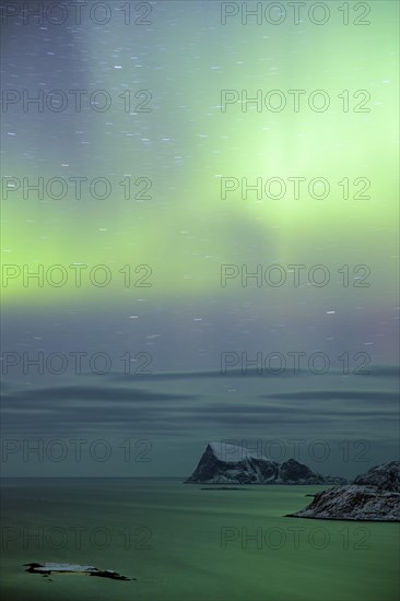 Fjord with islands in winter and the northern lights