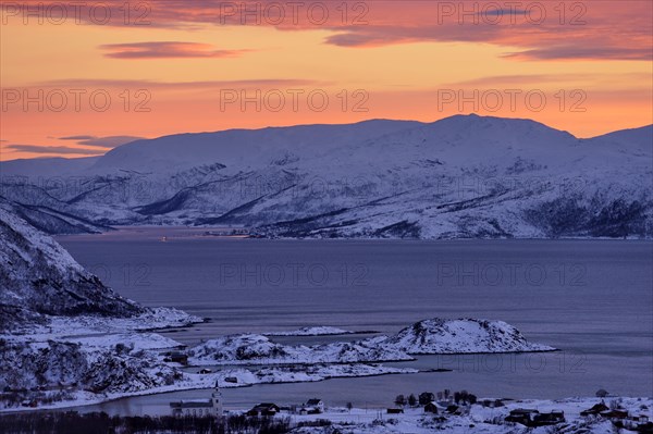 Fjord with islands in winter at sunset