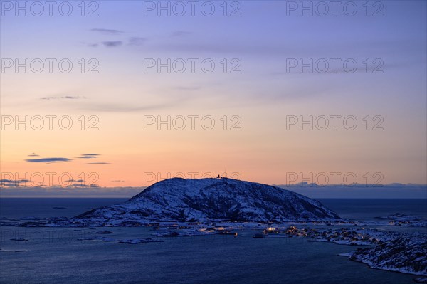 Fjord with mountains in winter at sunset