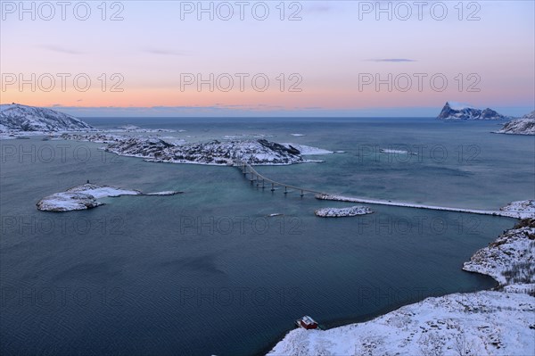 Fjord with islands and a bridge during the blue hour