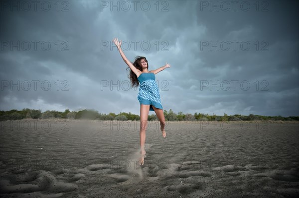 Girl jumping on a beach