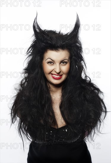 Young woman dressed as a devil with horns