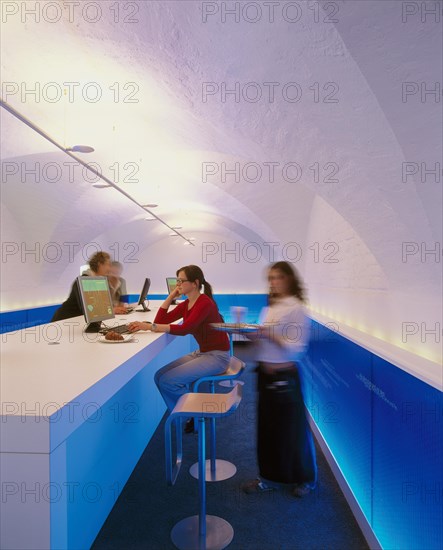 Futuristic Internet cafe with people