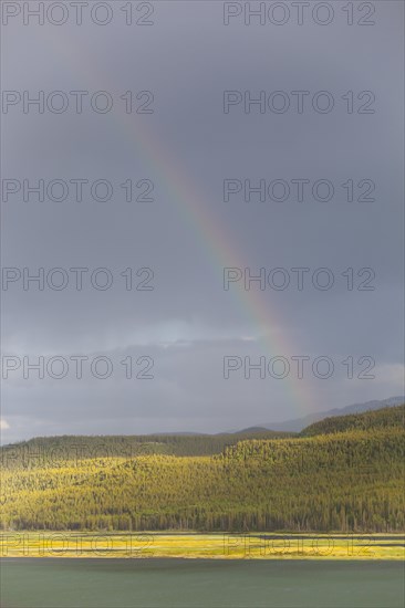 Heavy clouds and rainbow over Marsh Lake