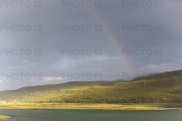 Heavy clouds and rainbow over Marsh Lake