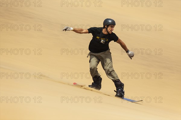 Man surfing the dunes