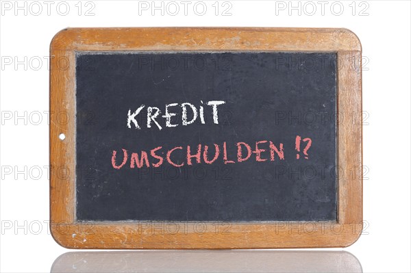 Old school blackboard with the words KREDIT UMSCHULDEN!?