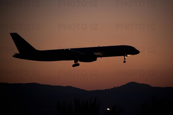 Aircraft approaching Dalaman Airport at dusk